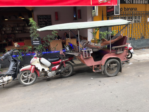Tut tut driver hard at work in Phnom Phen, Cambodia